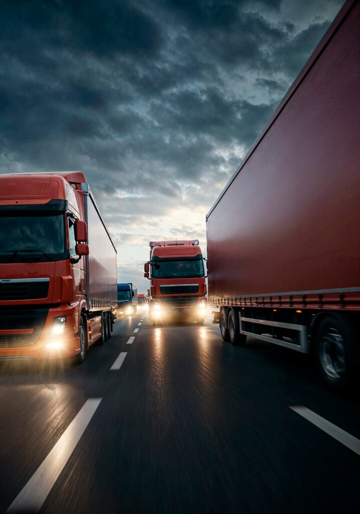 trucks driving highway dusk